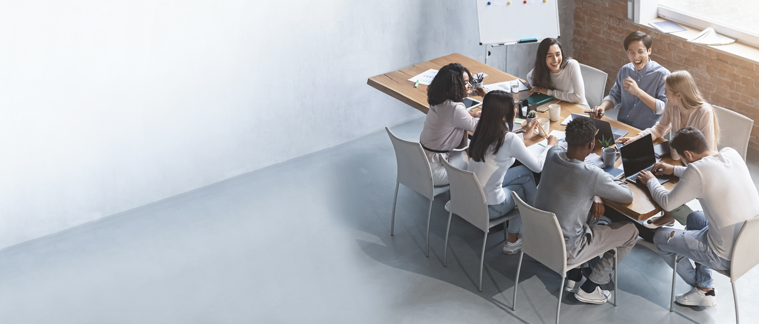 Young team sitting at a big table in a loft office space